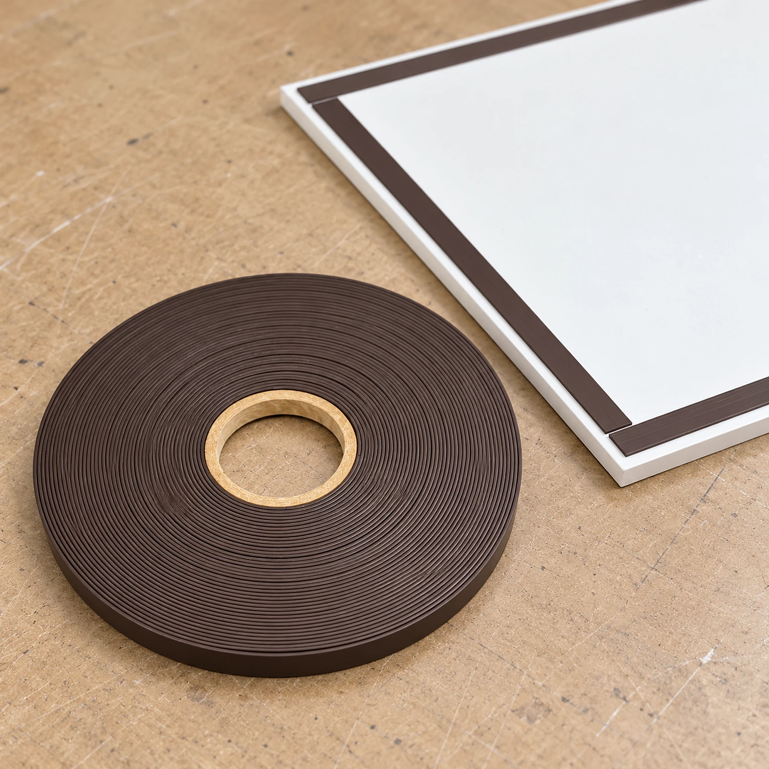 Roll of magnetic tape beside a panel edged with tape strips