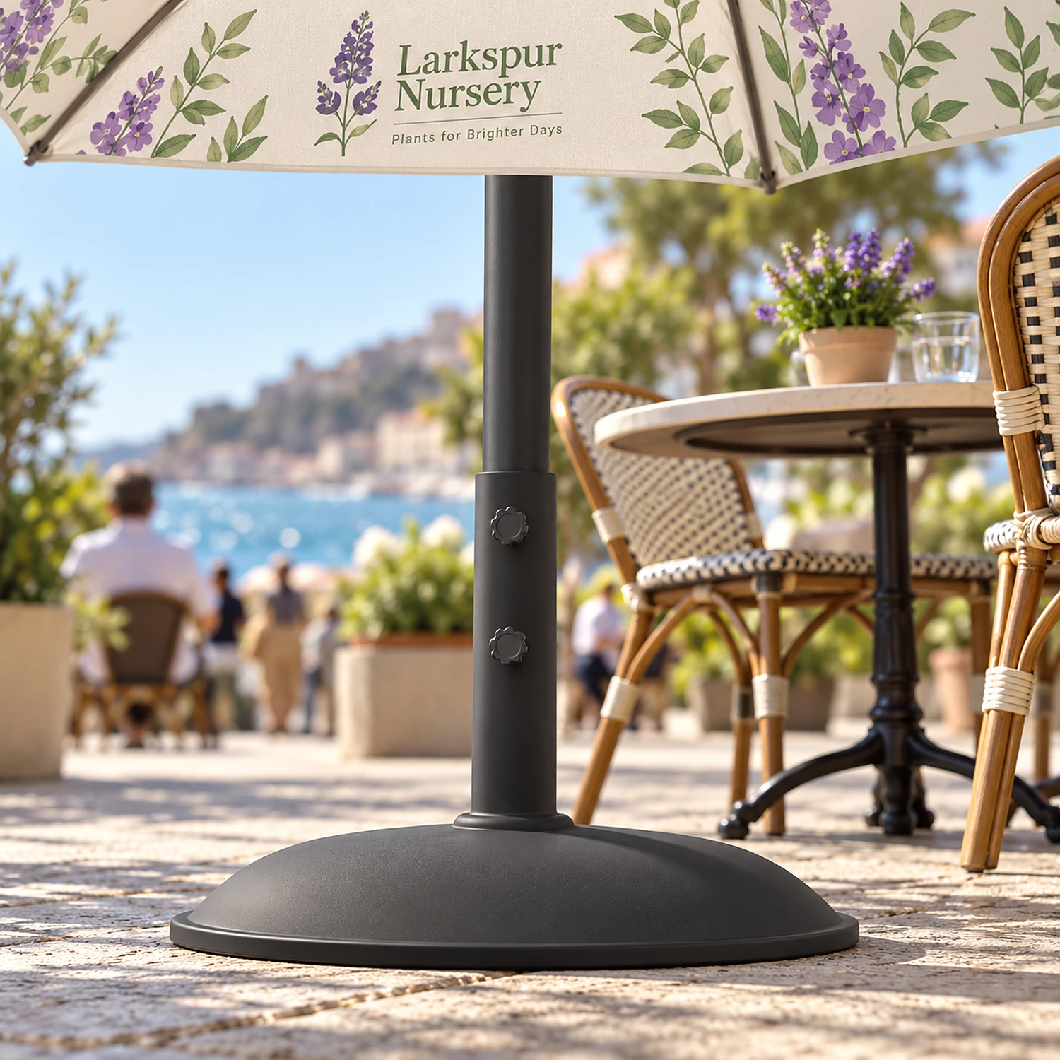 Parasol base holding a printed parasol at a seaside cafe