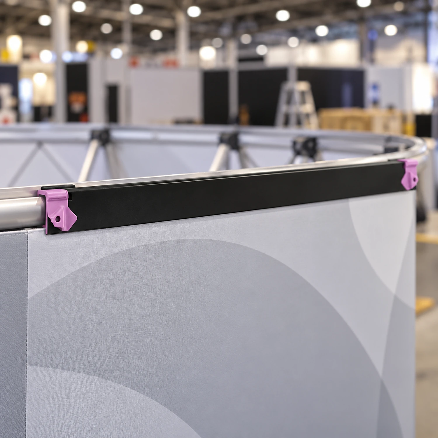 Hanger along the top of a panel on the back of a curved pop up stand
