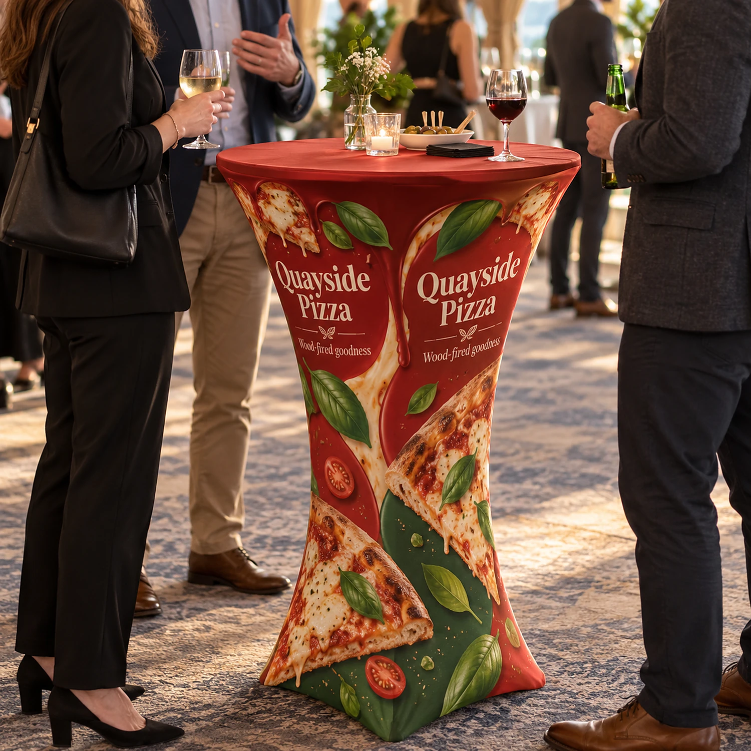 Round display table with printed cover at a networking event