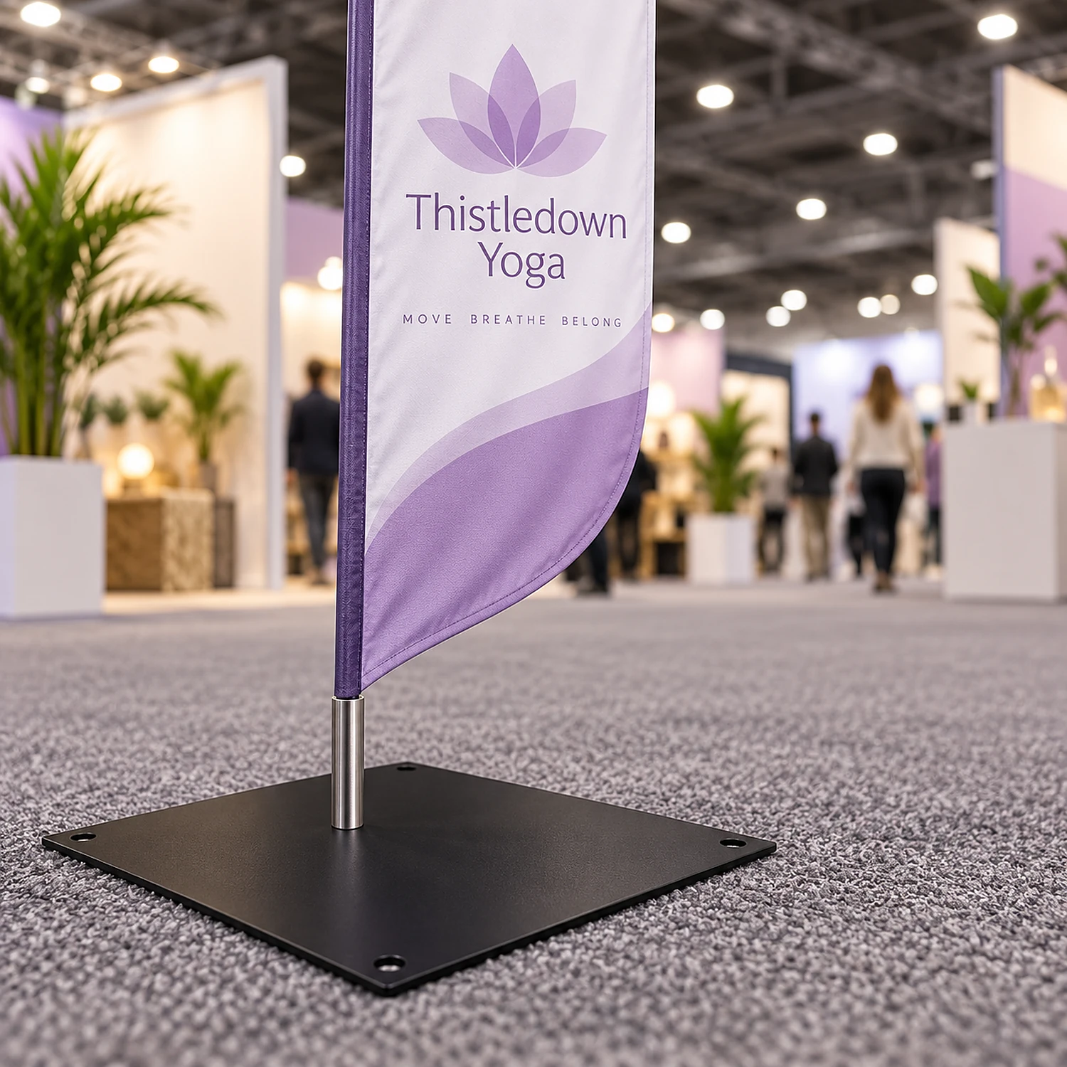 Square steel flag base holding a feather flag in an exhibition hall