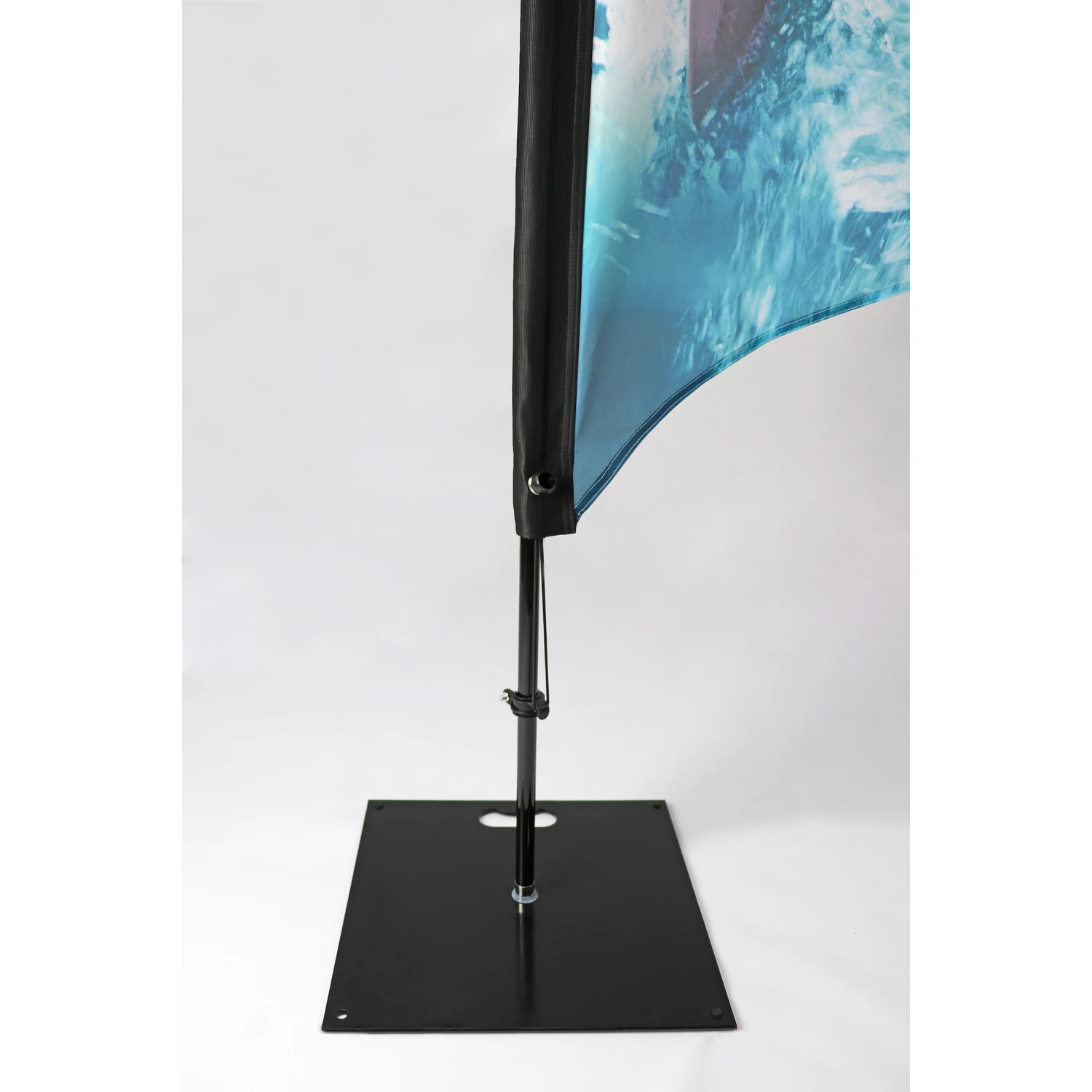 Square steel flag base and pole fitting under a fin flag