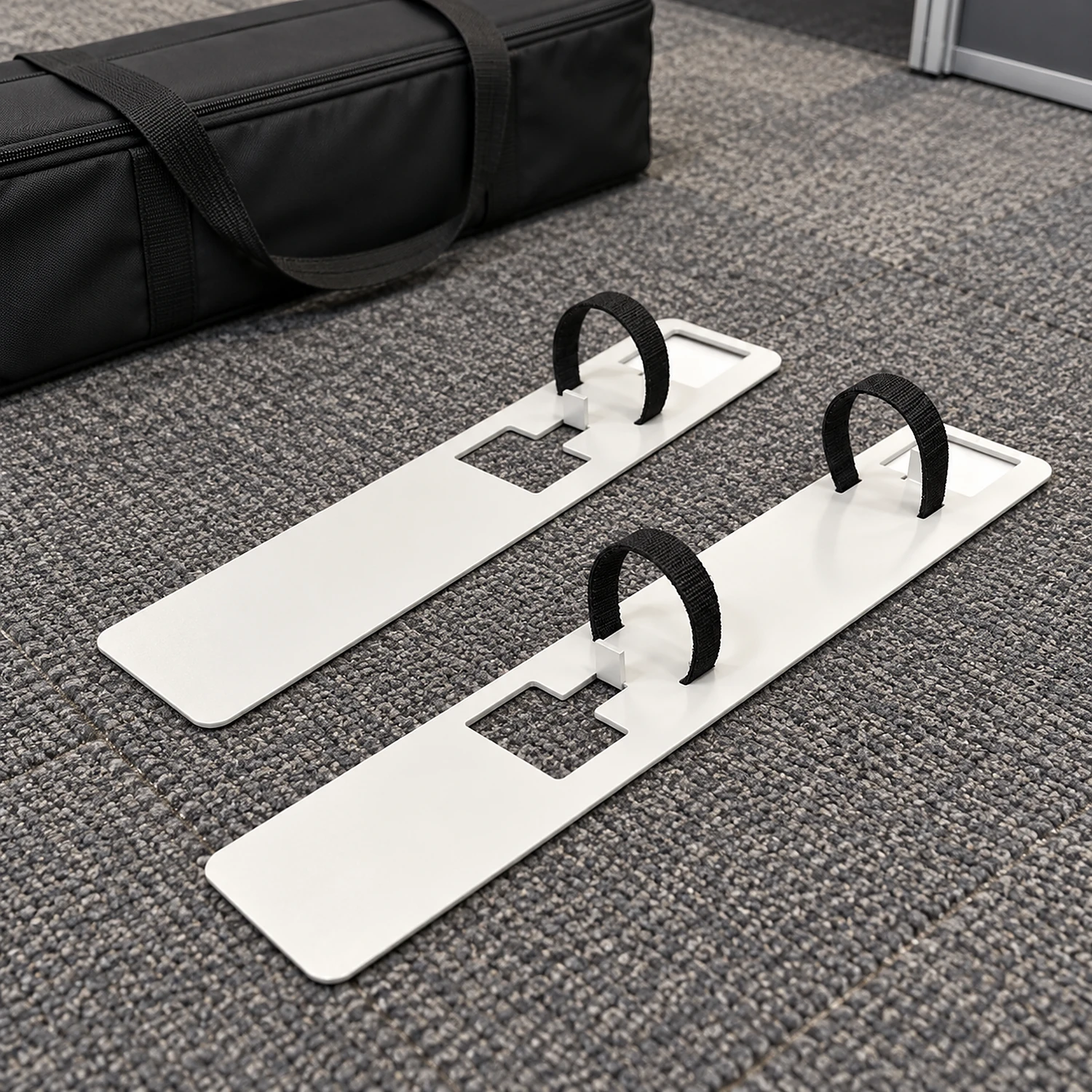 Pair of stabilising feet on exhibition hall carpet