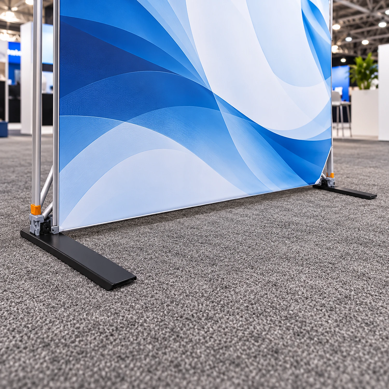 Pop up stand with a stabilising foot at each end at a trade show