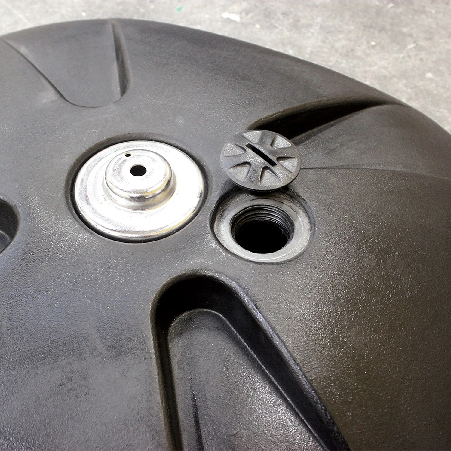 Top of the stackable flag base showing the pole socket and fill cap