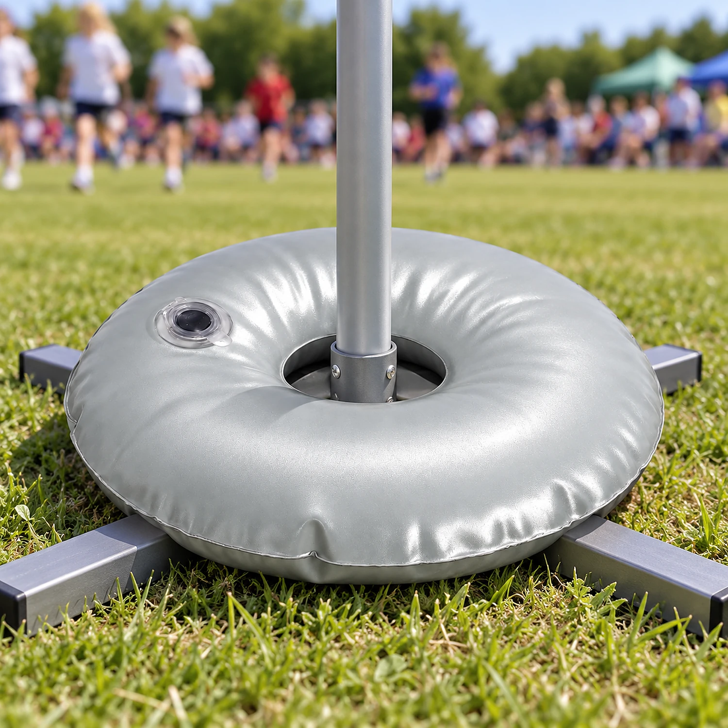 Water weight ring over a cross flag base on grass