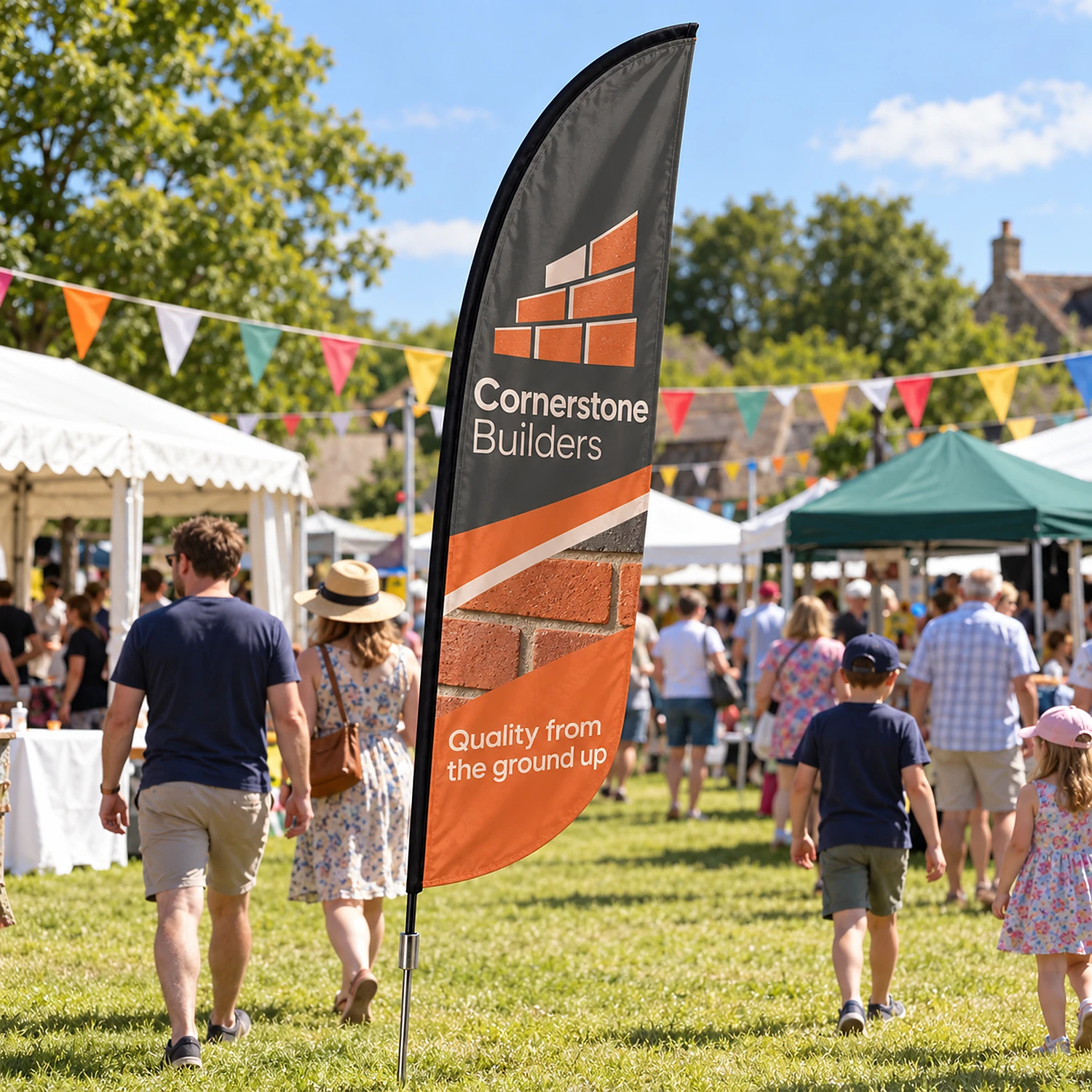 Zoom+ Crest Flag Set with Ground Spike in use at an outdoor village fete